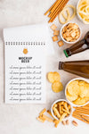 Top View Of Notebook With Selection Of Snacks And Beer Bottles Psd