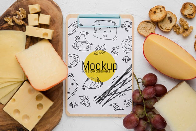Top View Of Notepad With Cheese And Grapes Psd