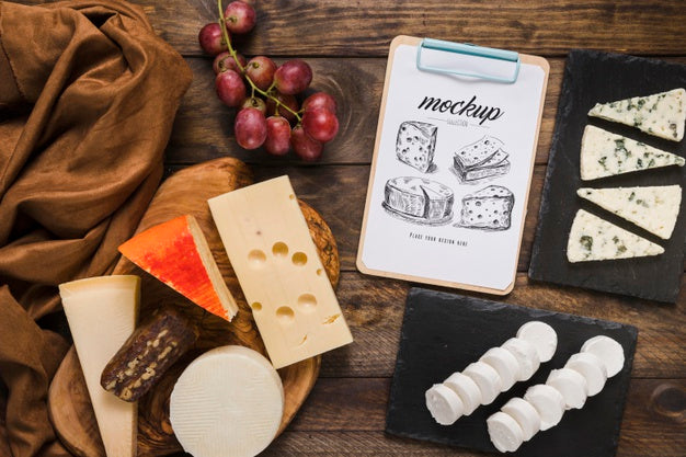Top View Of Notepad With Variety Of Cheese And Grapes Psd