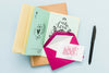 Top View Of Open Book With Envelope And Card Psd