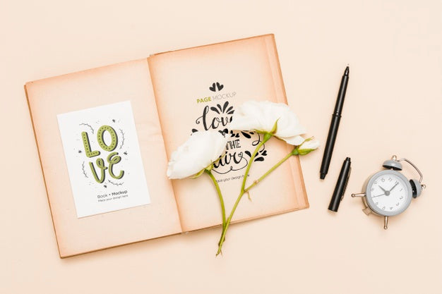 Top View Of Open Book With Roses And Clock Psd