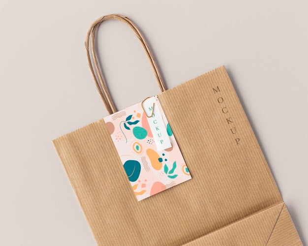 Top View Of Paper Shopping Bag Mock-Up With Paper Tag Psd