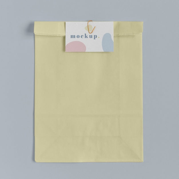 Top View Of Paper Shopping Bag Mock-Up With Paper Tag Psd