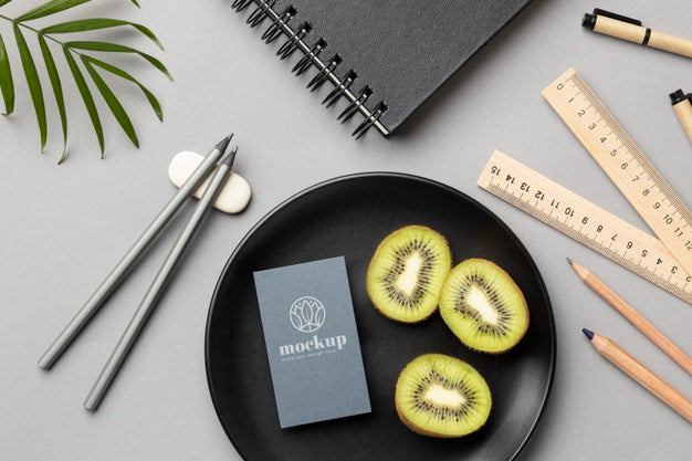 Top View Of Paper Stationery On Plate With Kiwi And Rulers Psd