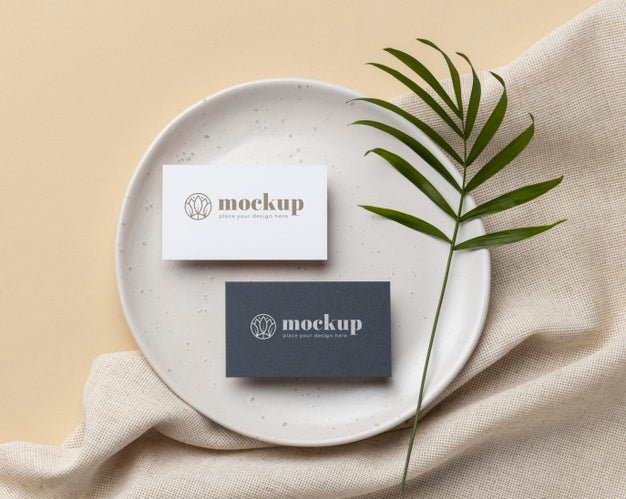 Top View Of Paper Stationery On Plate With Leaf Psd