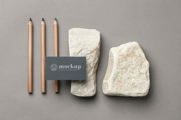Top View Of Paper Stationery With Stones And Pencils Psd