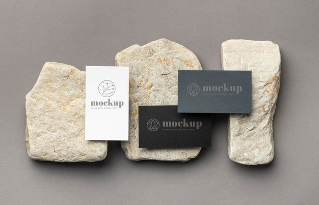 Top View Of Paper Stationery With Stones Psd