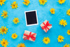 Top View Of Photo And Gifts With Yellow Chamomile Psd