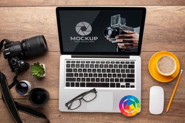 Top View Of Photographer Wooden Workspace With Laptop Psd