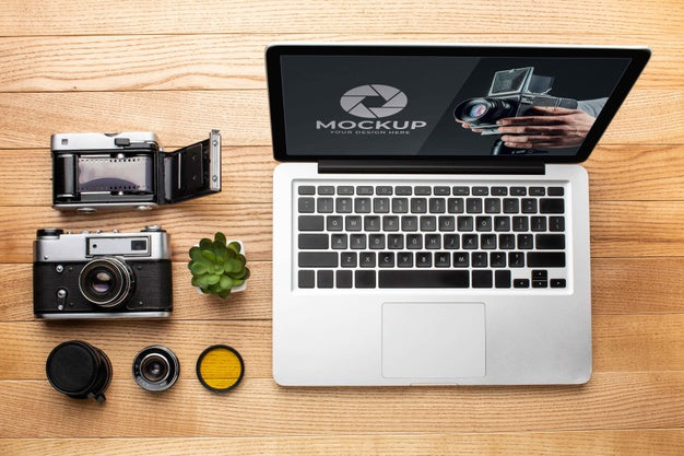 Top View Of Photographer Wooden Workspace With Laptop Psd