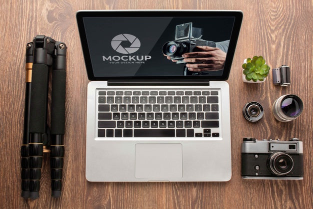 Top View Of Photographer Wooden Workspace With Laptop Psd