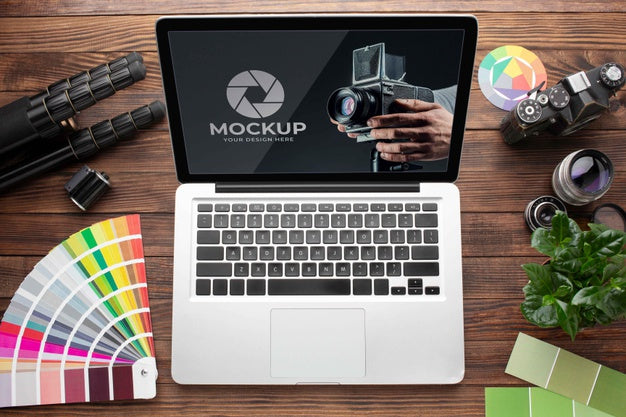 Top View Of Photographer Wooden Workspace With Laptop Psd