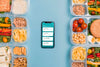 Top View Of Planned Meals With Smartphone Psd