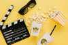 Top View Of Popcorn Cup With Clapperboard And Glasses Psd