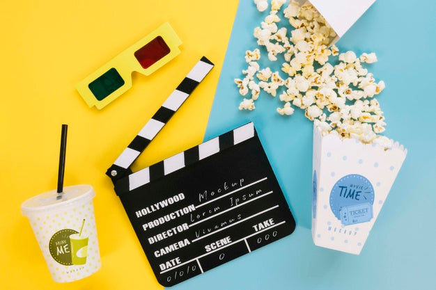 Top View Of Popcorn Cup With Clapperboard And Soda Psd