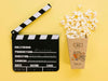 Top View Of Popcorn Cup With Clapperboard Psd