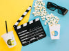 Top View Of Popcorn Cup With Glasses And Clapperboard Psd