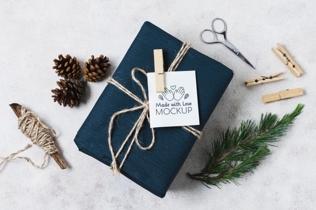 Top View Of Present With Scissors And Pine Cones Psd
