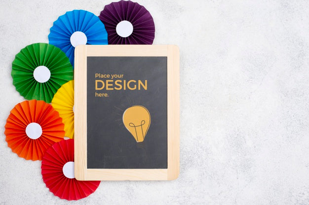 Top View Of Rainbow Colored Rosettes And Blackboard Psd