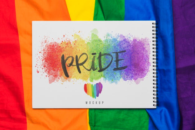 Top View Of Rainbow Colored Textile With Notebook Psd