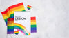 Top View Of Rainbow Flags And Notebook Psd
