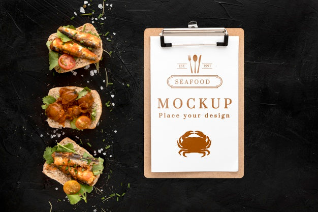 Top View Of Seafood Dishes With Notepad Psd