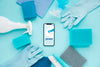 Top View Of Smartphone And Cleaning Solutions Psd