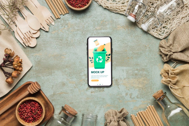 Top View Of Smartphone And Recycling Materials Psd