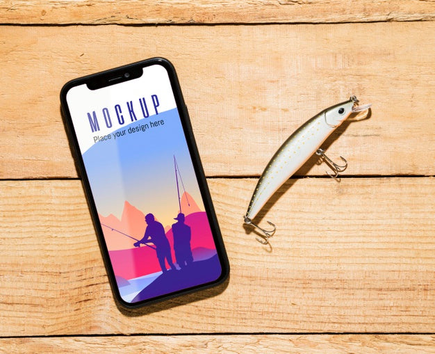 Top View Of Smartphone With Fish Bait Psd