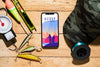 Top View Of Smartphone With Fishing Bait Psd