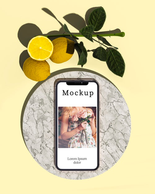 Top View Of Smartphone With Leaves And Lemons Psd