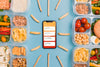 Top View Of Smartphone With Planned Meals Psd