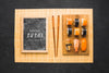 Top View Of Sushi On Chopping Board With Chopsticks And Blackboard Psd