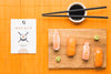 Top View Of Sushi On Chopping Board With Soy Sauce And Chopsticks Psd