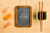 Top View Of Sushi With Chopsticks And Blackboard Psd