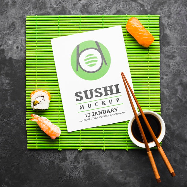 Top View Of Sushi With Chopsticks And Soy Sauce On Bamboo Roller Psd