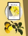 Top View Of Tablet With Citrus And Leaves Psd
