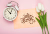 Top View Of Tulips With Clock And Card Psd