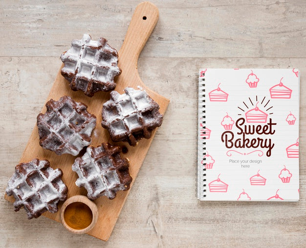 Top View Of Waffles On Chopping Board With Notebook Psd