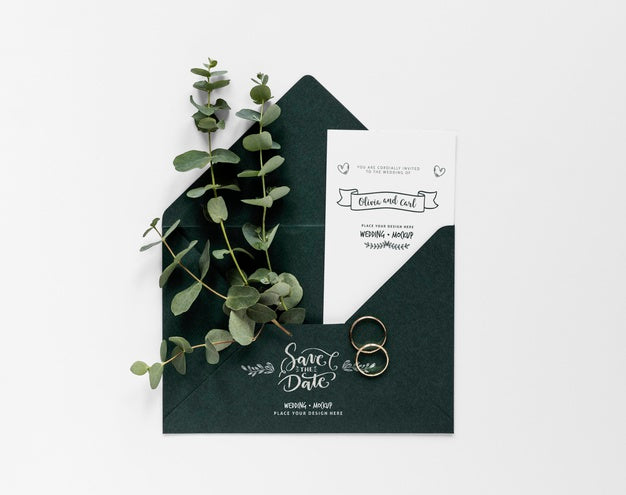 Top View Of Wedding Card With Plants And Rings Psd