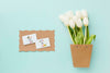 Top View Of White Tulips And Cards Psd
