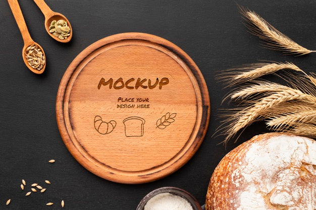 Top View Of Wooden Board With Bread And Wheat Psd