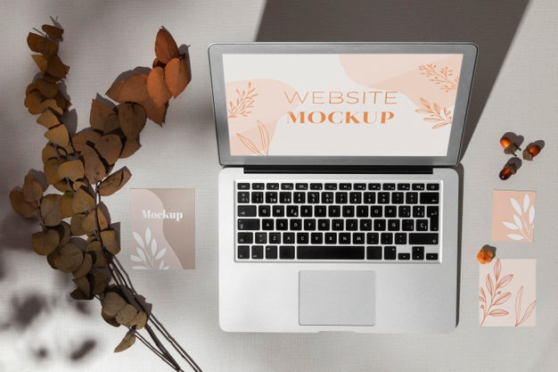 Top View Opened Laptop With Screen Mockup Next To Leaves Psd