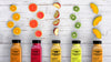 Top View Plastic Bottles Of Smoothies And Slices Of Fruit Psd