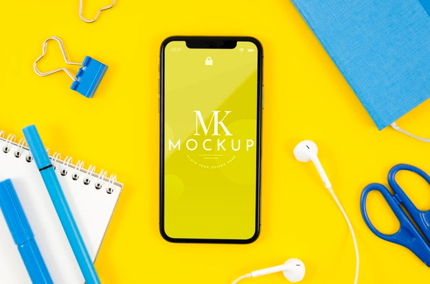 Top View Smartphone Mock-Up With Earphones And Stationery Psd