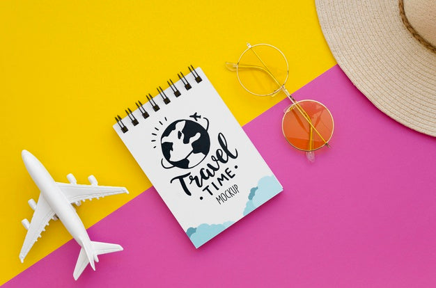 Top View Travelling Plane And Notepad With Lettering Psd