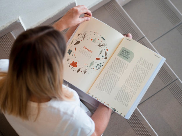 Top View Woman Looking Into A Mock Up Magazine Psd