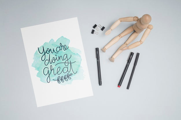 Top View Wooden Doll With Pens Psd