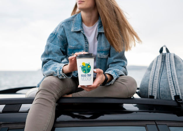 Traveler Holding A Mock-Up Cup Of Coffee Psd