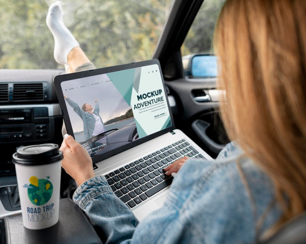 Traveler Holding A Mock-Up Laptop Psd